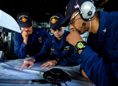 US Navy 110604-N-AQ172-206 Sailors plots navigation points on a chart