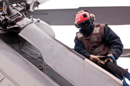 US Navy 110608-N-BT887-101 Airman Rashid Smith secures the rotor blade of an MH-60S Sea Hawk helicopter aboard USS John C. Stennis (CVN 74)