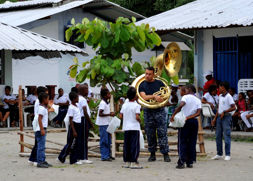 US Navy 110606-F-ET173-059 Musician 3rd Class Christopher Roland, from Blair, Okla., talks with a group of students before a concert at Institucion