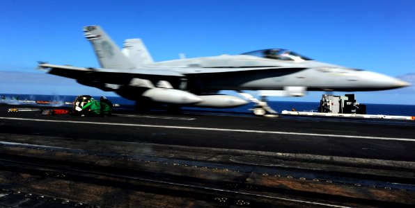 US Navy 110604-N-OY799-033 Catapult crew members duck as an F-A-18C Hornet from the Golden Dragons of Strike Fighter Squadron (VFA) 192 launches fr