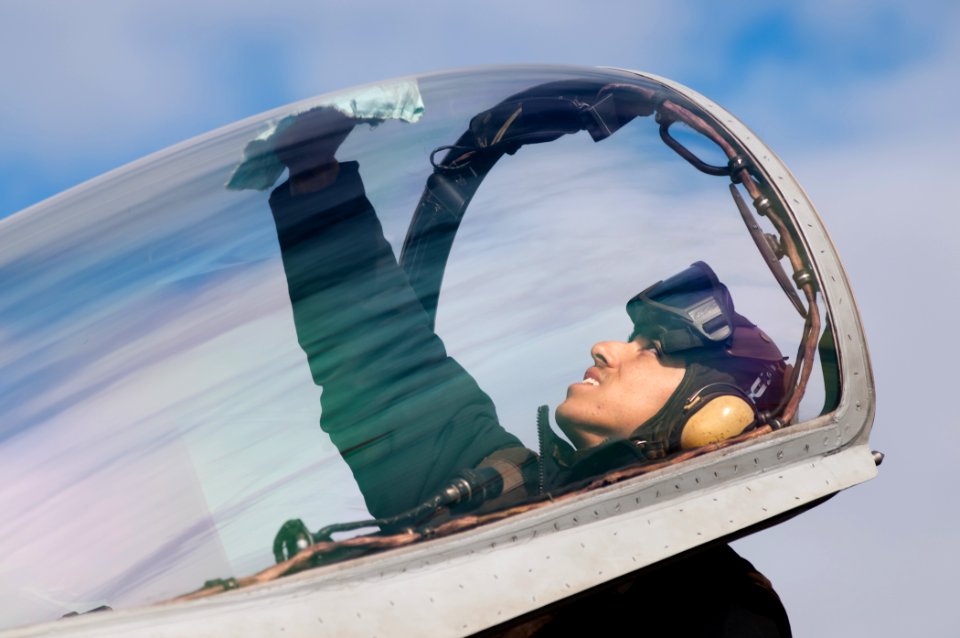 US Navy 110606-N-BT887-007 Aviation Machinist's Mate Airman Julian Parrera, from Bogata, Columbia, cleans the canopy of an F-A-18C Hornet from the