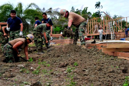 US Navy 110605-F-NJ219-280 Navy personnel embarked aboard the Military Sealift Command hospital ship USNS Comfort (T-AH 20) dig holes for new sewag photo