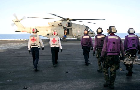 US Navy 110606-N-OP638-058 Sailors aboard the aircraft carrier USS Enterprise (CVN 65) approach a Royal Navy Merlin HM MK 1 helicopter that transpo
