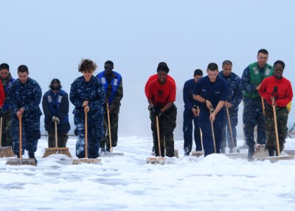 US Navy 110605-N-DS193-016 Sailors join a working party to scrub down the flight deck of the aircraft carrier USS George Washington (CVN 73) during photo