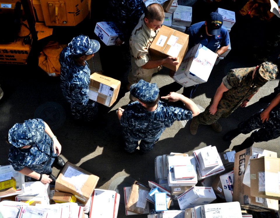 US Navy 110608-O-ZZ999-003 Sailors aboard USS Cleveland (LPD 7) sort mail during mail call