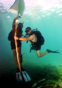 US Navy 110608-N-XD935-079 Navy Diver 2nd Class Justin McMillen holds the lift line as Ordinary Seaman Romando Thomas fills air into a lift bag