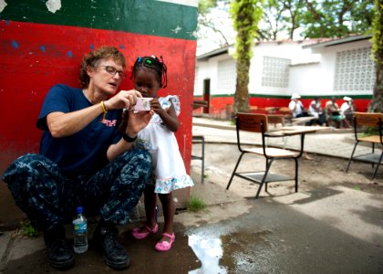US Navy 110606-N-NY820-268 Lt. Cmdr. Linda Wisman shows photos on her camera to a child at Escuela Max Seidel during a Continuing Promise 2011 comm photo