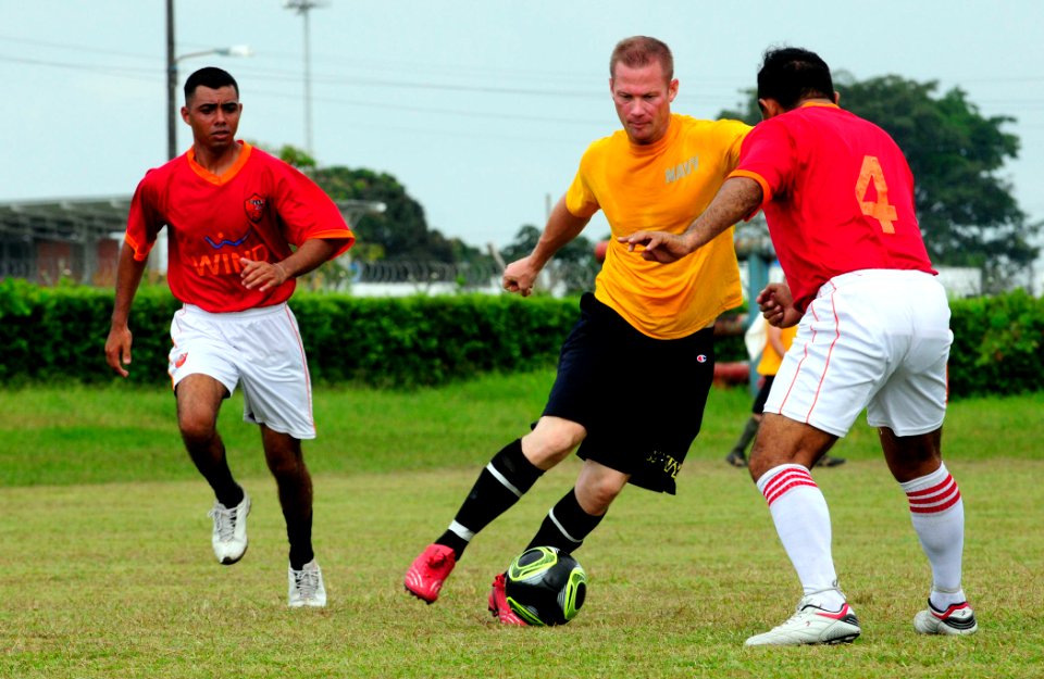 US Navy 110605-N-EP471-215 Lt. Joshua Fair, from Canton, Mich., dribbles the ball toward a defender in an exhibition soccer match during a Continui