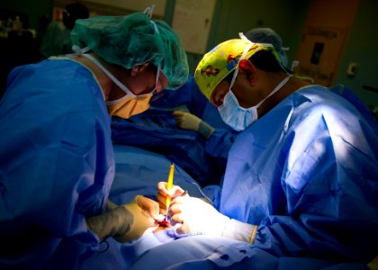 US Navy 110605-N-RM525-168 Dr. Jorge Valencia, right, a pediatric surgeon from Mexico, and Capt. Beth Jaklic, a Navy surgeon, perform hernia repair