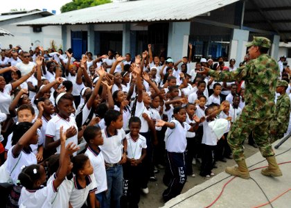 US Navy 110606-F-ET173-104 A Colombian marine sings for a group of students at Institucion Ciudadela Educativa Tumaco Narino during a Continuing Pr