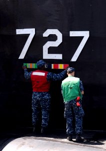 US Navy 110608-N-GU530-182 Sailors assigned to the Blue Crew of the Ohio-class guided-missile submarine USS Michigan (SSGN 727) attach Michigan's h