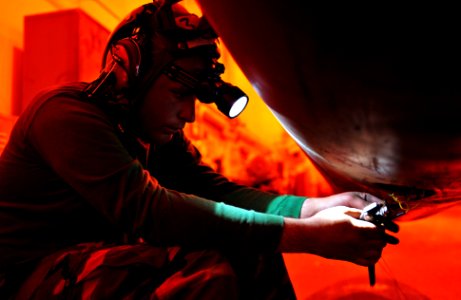 US Navy 110606-N-GC412-107 Aviation Electrician's Mate 3rd Class Brandon Notz, from Boise, Idaho, rewires a valve on a external drop fuel cell on a