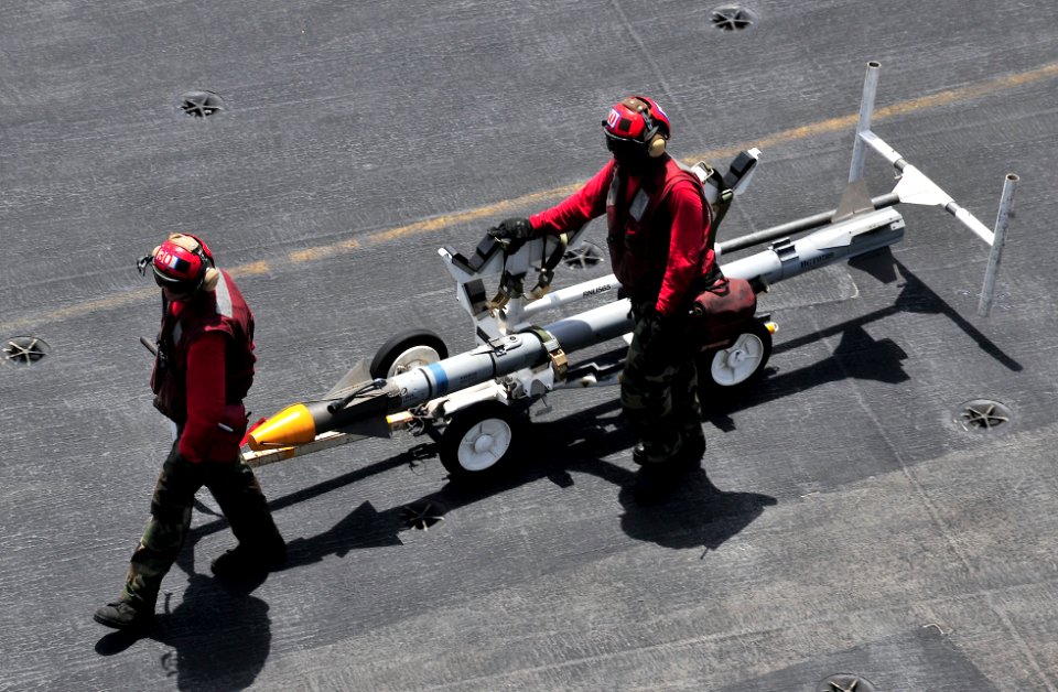 US Navy 110607-N-OP638-009 Aviation Ordnancemen assigned to the aircraft carrier USS Enterprise (CVN 65) move ordnance off the flight deck during f