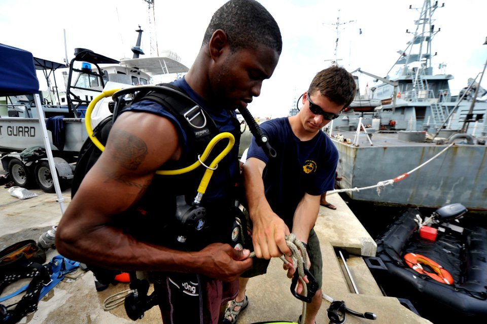 US Navy 110608-N-KB666-067 Navy Diver 2nd Class Ryan Arnold, assigned to Mobile Diving and Salvage Unit (MDSU) 2, instructs Constable Drew Charles