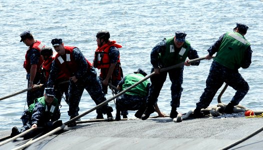 US Navy 110608-N-GU530-202 ailors assigned to the Blue Crew of the Ohio-class guided-missile submarine USS Michigan (SSGN 727) heave mooring lines