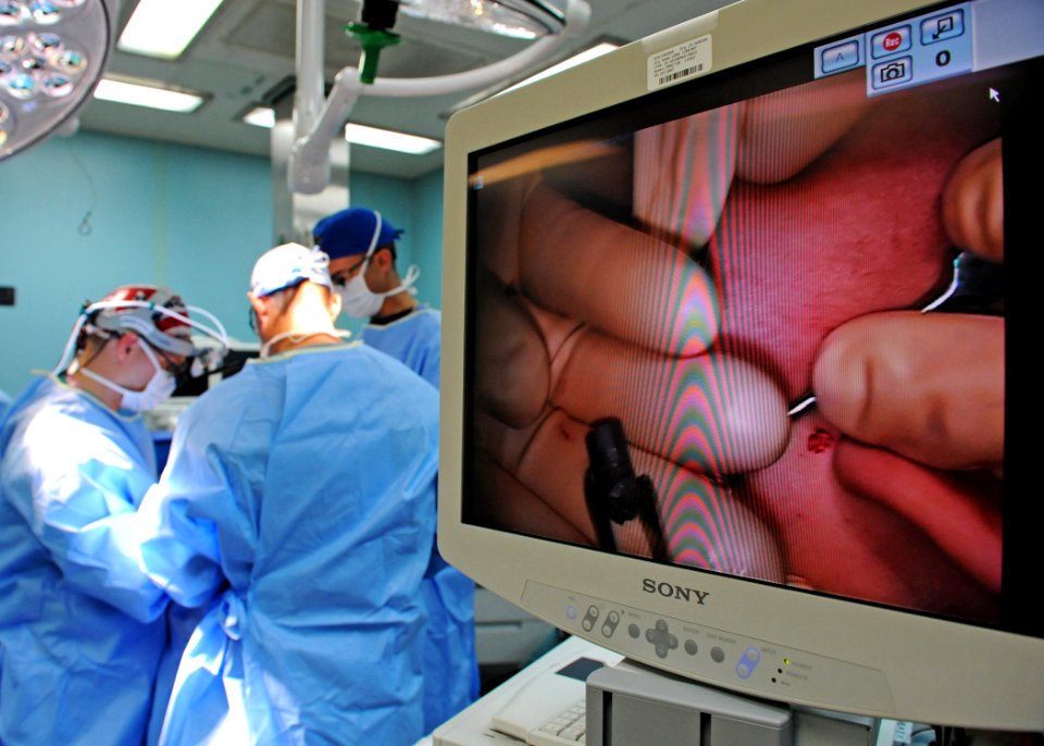 US Navy 110608-N-NY820-058 Doctors remove a bullet from a 23-year-old Colombian woman's cheek during a Continuing Promise 2011 medical community se