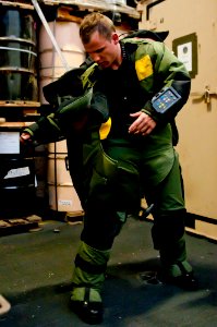 US Navy 110608-N-BT887-392 Midshipman James Dendy removes an explosive ordnance disposal suit aboard USS John C. Stennis (CVN 74)