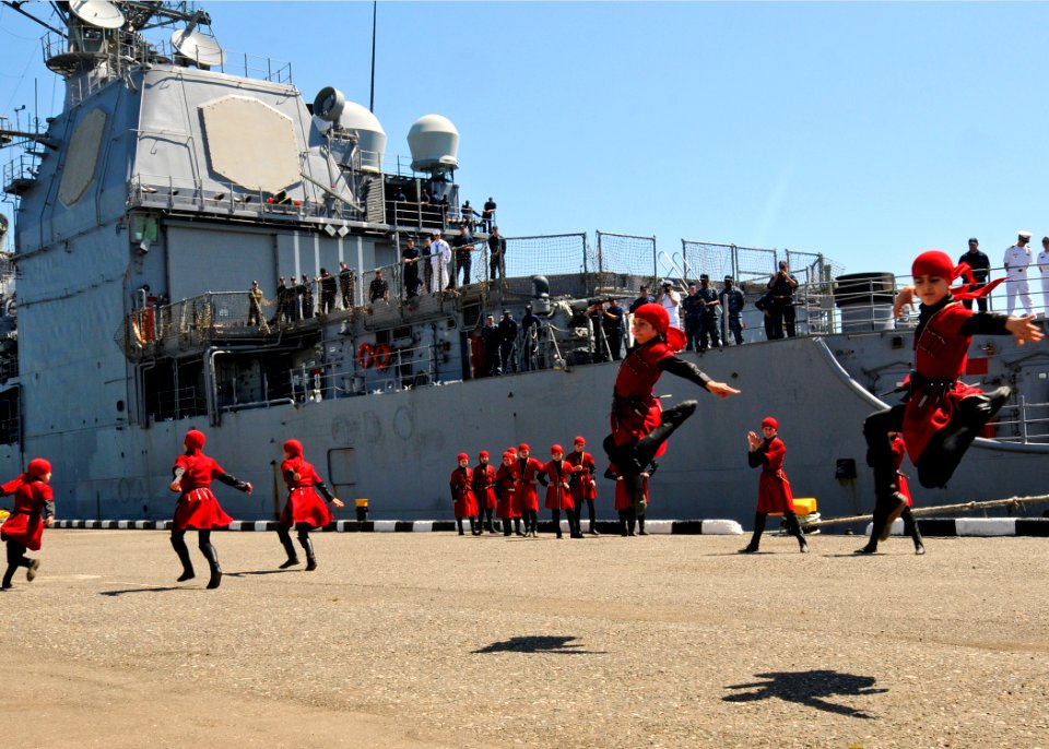US Navy 110609-N-YM590-106 Children dance during a welcoming ceremony for the guided-missile cruiser USS Anzio (CG 68) as the ship arrives for a po