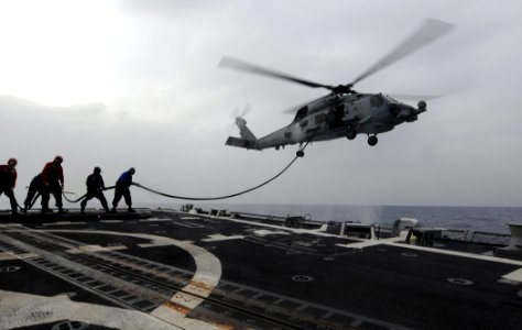 US Navy 110608-N-TB177-552 Sailors hold a fuel line during a helicopter in flight refueling exercise aboard the guided-missile destroyer USS Truxtu