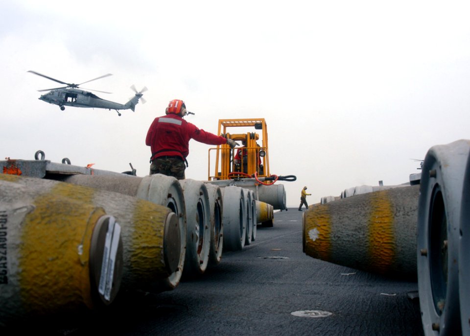 US Navy 110607-N-JO245-056 Sailors assigned to the weapons department of the aircraft carrier USS George Washington (CVN 73) move ordnance across t