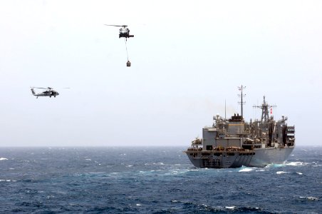 US Navy 110607-N-RC734-033 MH-60S Sea Hawk helicopters carry supplies between USNS Bridge (T-AOE 10) and USS Comstock (LSD 45) during a vertical re