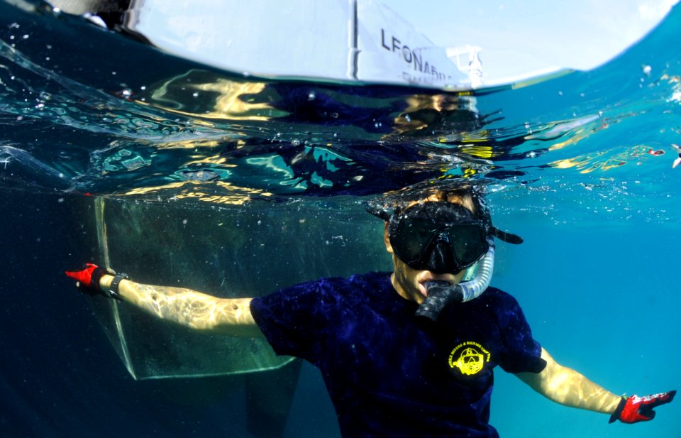US Navy 110607-N-XD935-192 Navy Diver 1st Class Jimmy Sotelo snorkels on the surface monitoring multinational divers below conducting diving operat