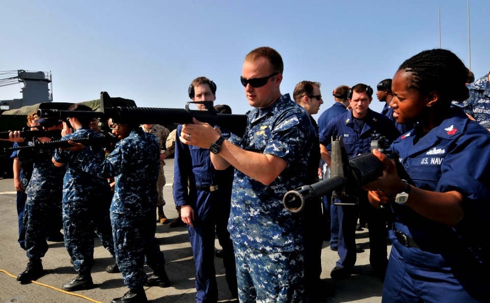 US Navy 110608-N-AG285-173 Lt. j.g. David Pagan, left, instructs Yeoman 1st Class Pamela McLean, right, during an M-16 service rifle qualification