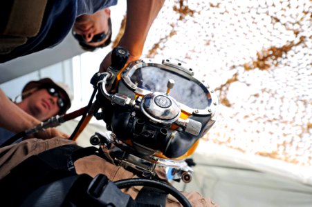 US Navy 110611-N-WL435-069 Chief Navy Diver Billy Goold conducts a pre-dive inspection on a U.S. Army diver