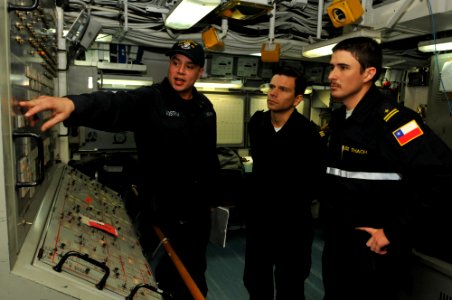 US Navy 110608-N-NL541-024 Gas Turbine Mechanic Fireman Jason Lindstrom, assigned to the guided-missile frigate USS Thach (FFG 43), explains the da