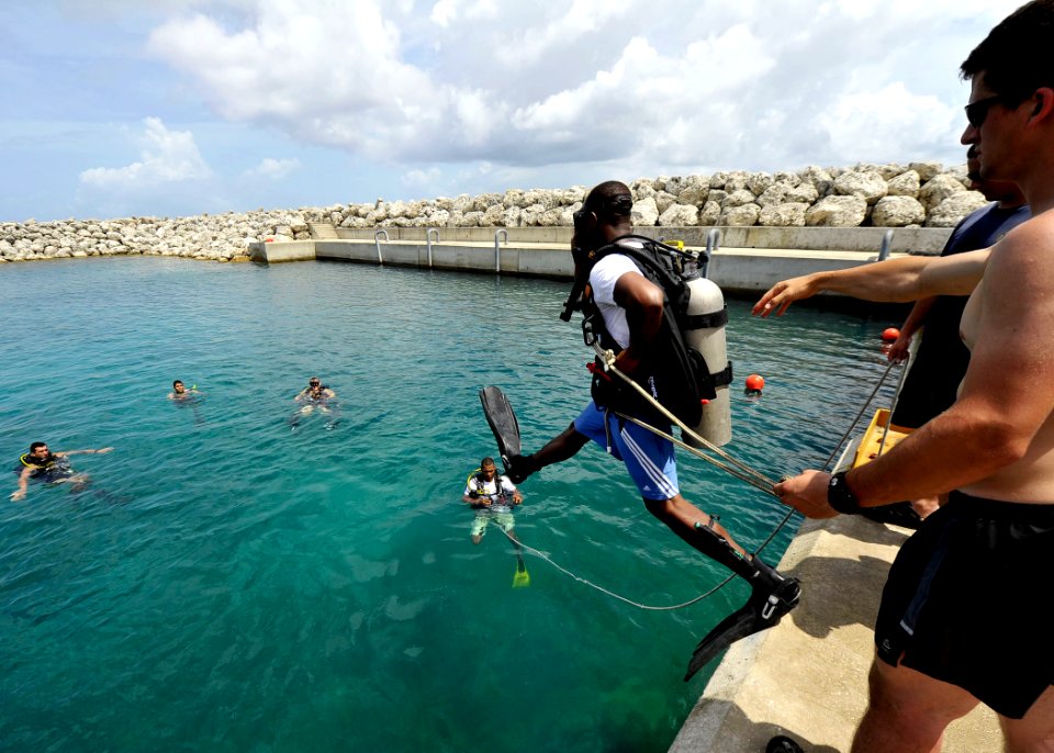US Navy 110608-N-KB666-147 Navy Diver 2nd Class Ryan Arnold, assigned to Mobile Diving and Salvage Unit (MDSU) 2, helps Constable Guaeline Brouet,