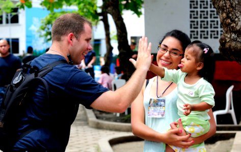 US Navy 110609-N-EP471-242 Hospital Corpsman 2nd Class Kirby Boudreaux plays a game with a young patient during a Continuing Promise 2011 community