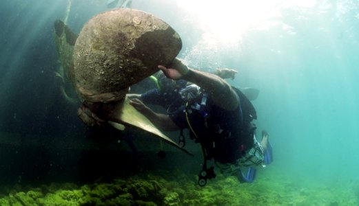 US Navy 110608-N-XD935-486 ble Body Seaman Jason Austin uses a lift bag system to move a sunken ship's propeller during an underwater lift