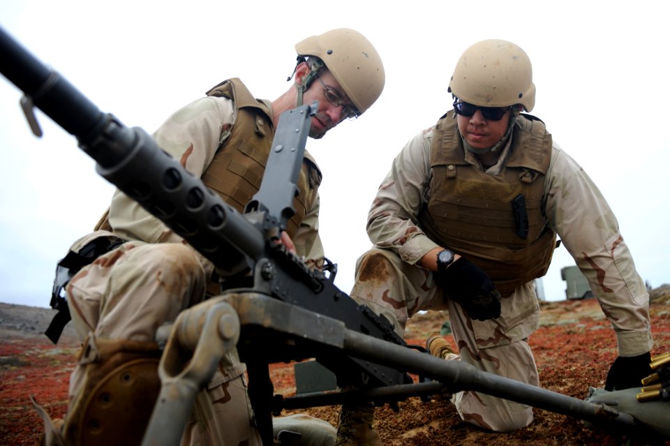 US Navy 110609-N-PM781-341 Gunner's Mate 2nd Class Jeffrey Kirkpatrick, left, and Gunner's Mate 2nd Class Anthony Koll inspect a .50 caliber machin