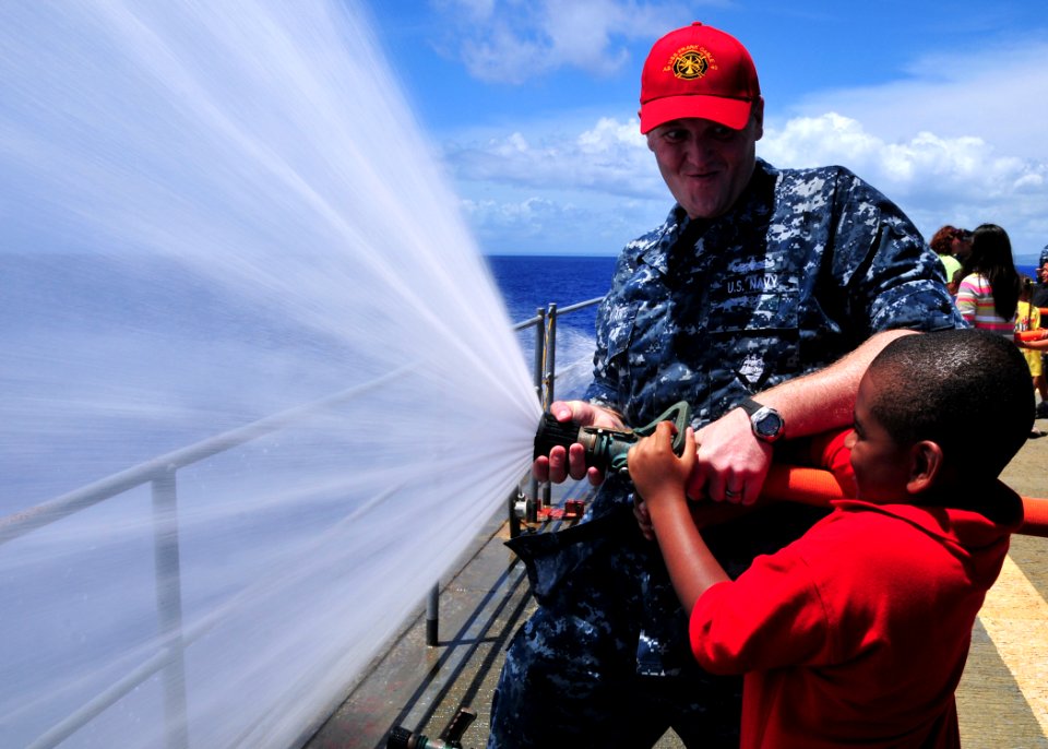 US Navy 110609-N-BK435-116 Damage Controlman 2nd Class Anthony Kevan, assigned to the submarine tender USS Frank Cable (AS 40), teaches hose handli