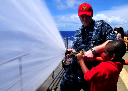US Navy 110609-N-BK435-116 Damage Controlman 2nd Class Anthony Kevan, assigned to the submarine tender USS Frank Cable (AS 40), teaches hose handli
