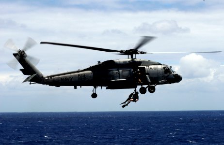 US Navy 110611-N-GZ277-278 An SH-60F Sea Hawk helicopter assigned to Helicopter Anti-submarine Squadron (HS) 15, deploys a rescue swimmer over the