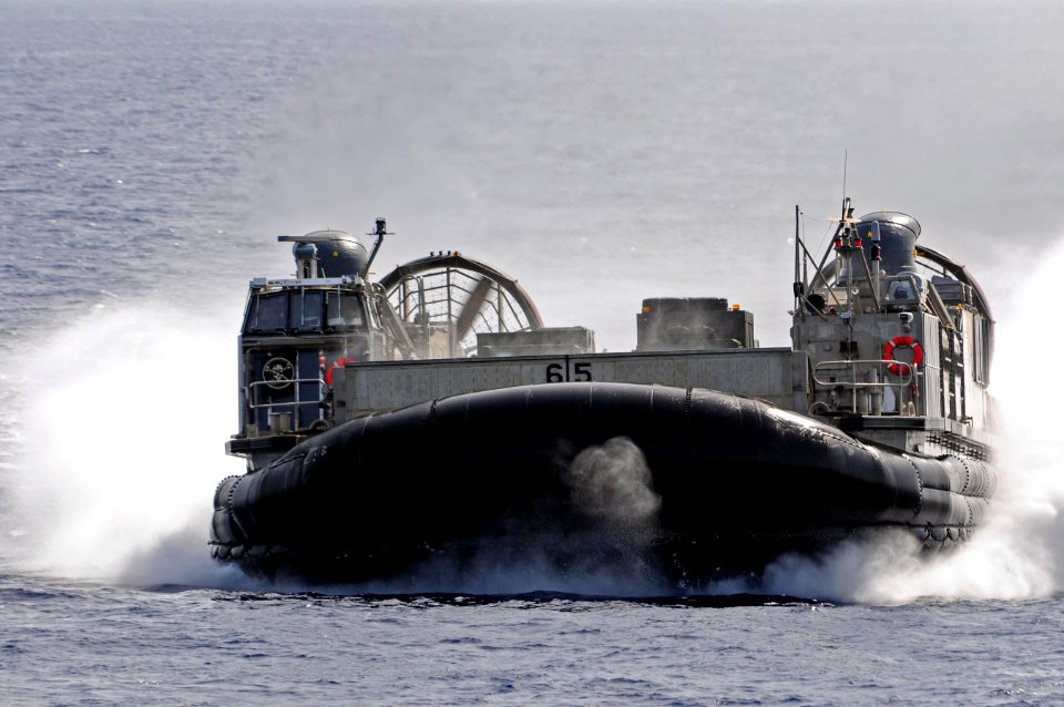 US Navy 110610-N-RC734-012 Landing Craft Air Cushion (LCAC) 65 approaches the well deck of USS Comstock (LSD 45)