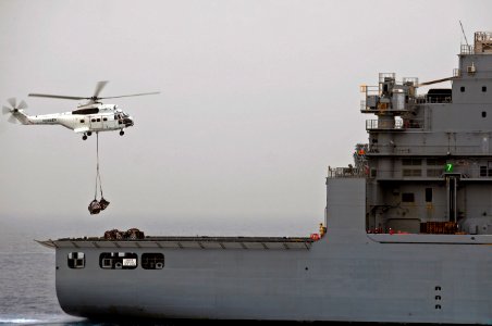 US Navy 110613-N-RC734-037 An AS-332 Super Puma helicopter picks up cargo from USNS Alan Shepard (T-AKE 3) during a vertical replenishment