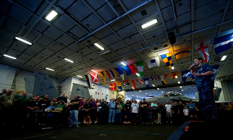 US Navy 110610-N-TU221-604 Lt. Nomer Gatchalian gives a safety brief to Sailors, friends and family in the hangar bay aboard the Nimitz-class aircr