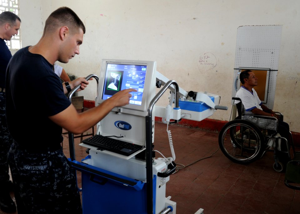 US Navy 110610-N-QD416-104 Hospital Corpsman 2nd Class Robert Hooffstetter takes an X-ray of a man paralyzed by a shotgun blast at the Escuela Max