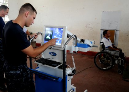 US Navy 110610-N-QD416-104 Hospital Corpsman 2nd Class Robert Hooffstetter takes an X-ray of a man paralyzed by a shotgun blast at the Escuela Max
