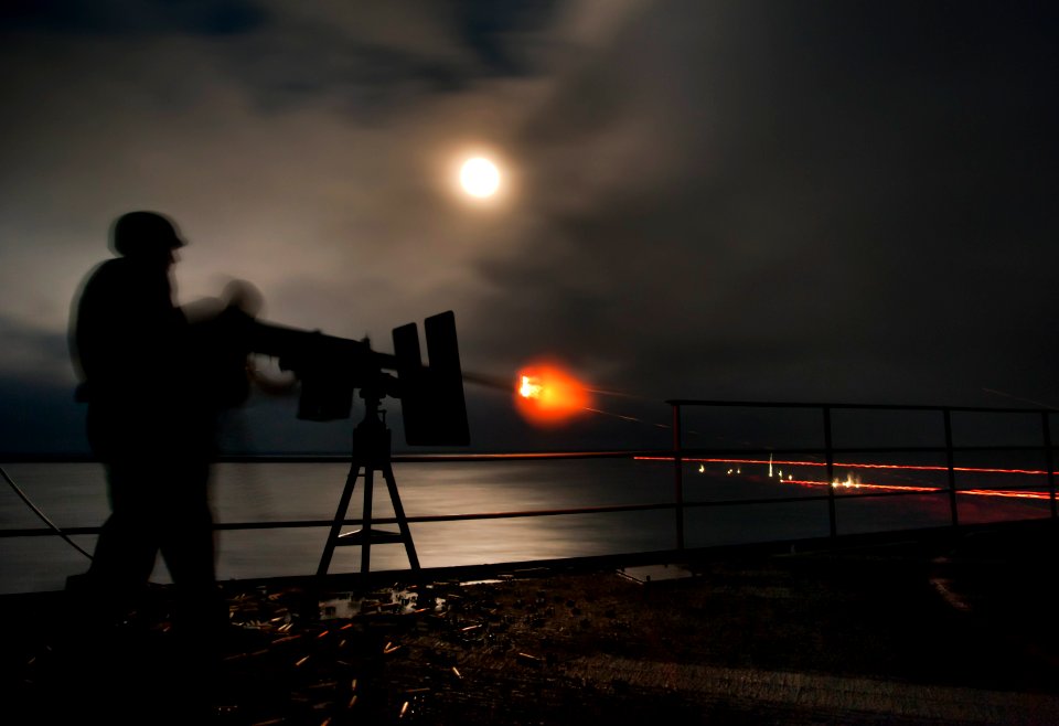 US Navy 110613-N-DR144-644 Aviation Ordnanceman 2nd Class Jacob Lopez and Chief Aviation Ordnanceman Jeff Givens fire a .50 caliber machine gun