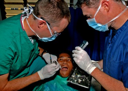 US Navy 110610-N-NJ145-224 Lt. Barak Wray, left, and Hospital Corpsman Jared Myers extract a tooth