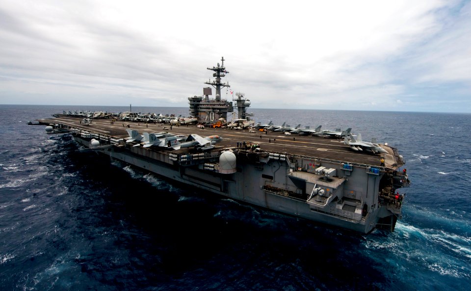 US Navy 110611-N-TU221-075 The Nimitz-class aircraft carrier USS Carl Vinson (CVN 70) maneuvers at sea during a tiger cruise air show