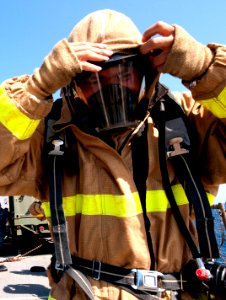 US Navy 110611-N-QP268-416 Boatswain's Mate Seaman Boyu Huang dons a self-contained breathing apparatus during the damage control Olympics aboard U