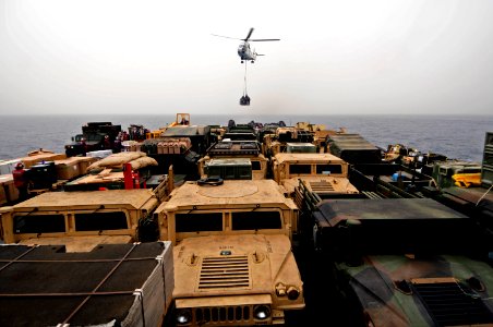 US Navy 110613-N-RC734-032 An AS-332 Super Puma helicopter delivers cargo aboard USS Comstock (LSD 45) during a vertical replenishment