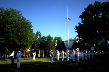 US Navy 110614-N-HG258-045 The U.S. Navy Ceremonial Band performs the national anthem as the American flag is raised during morning colors photo