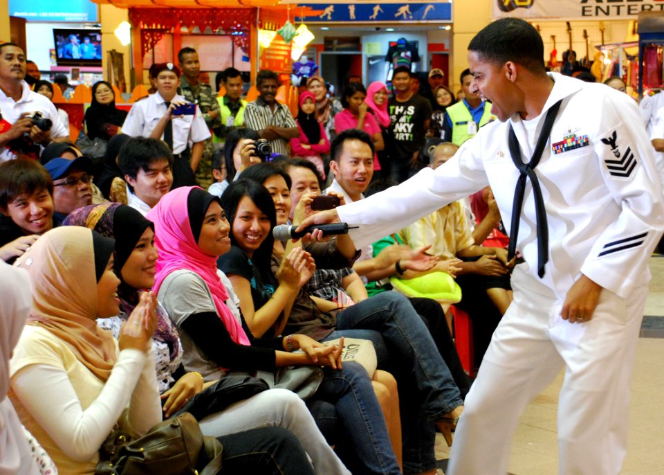 US Navy 110610-N-VP123-137 Musician 1st Class Christopher Sams enlists the help of the audience for a Michael Jackson song during a concert at Kuan
