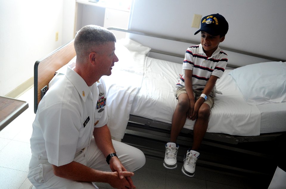 US Navy 110614-N-AD372-037 Master Chief Petty Officer of the Navy (MCPON) Rick D. West makes a child an honorary Sailor with a command ball cap fro