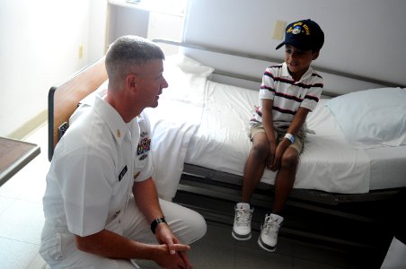 US Navy 110614-N-AD372-037 Master Chief Petty Officer of the Navy (MCPON) Rick D. West makes a child an honorary Sailor with a command ball cap fro